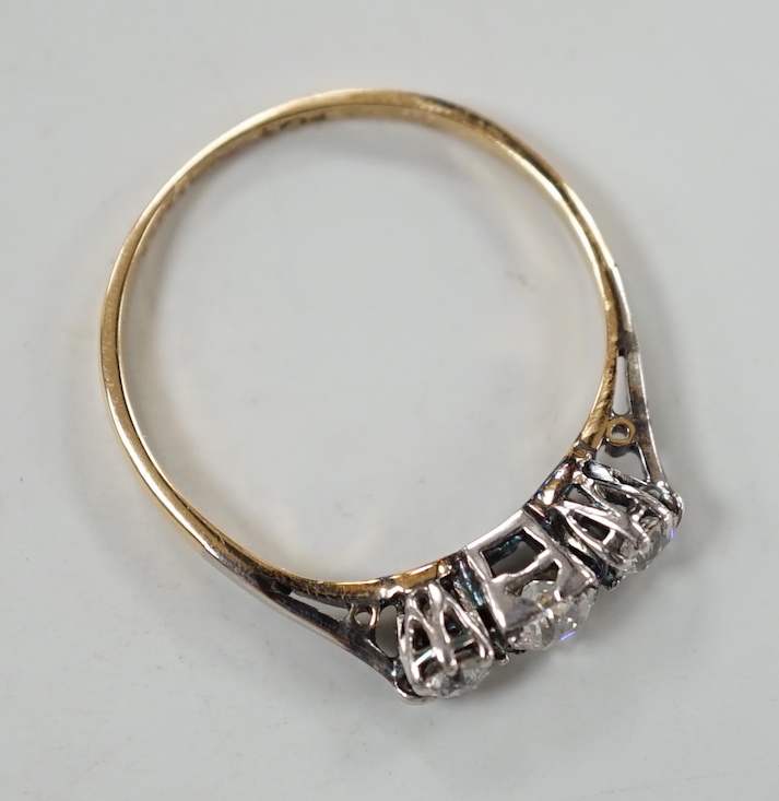 A yellow metal, plat and three stone diamond set ring, size P, gross weight 2 grams.